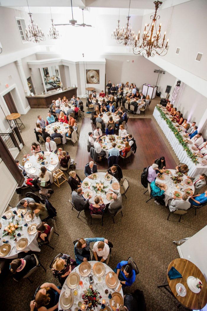 Overhead view of a wedding venue with 130 guests seated eating dinner