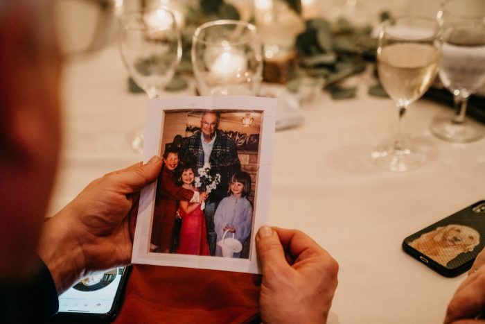 Guest holding a photo of family members